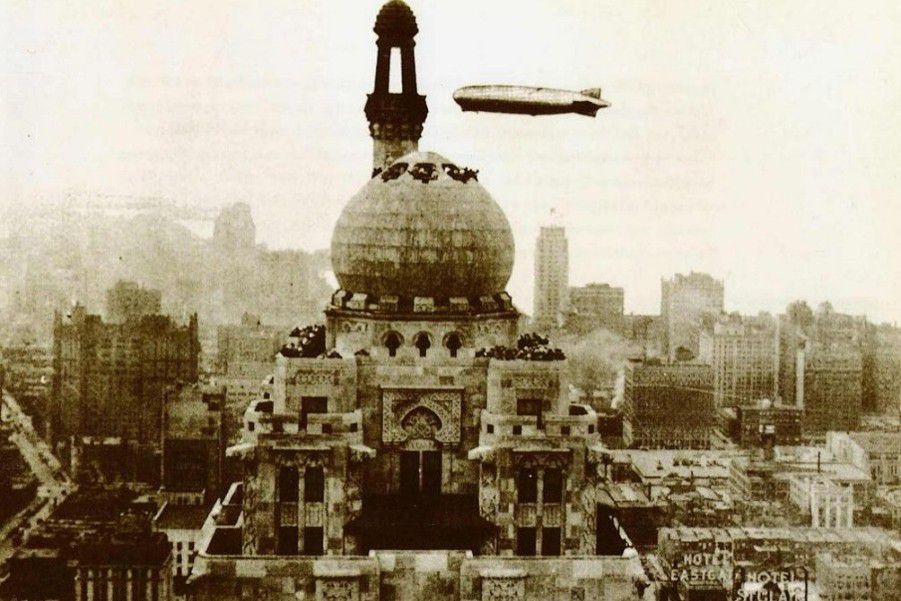 Historic photograph of the Medinah Athletic Club building with dirigible overhead