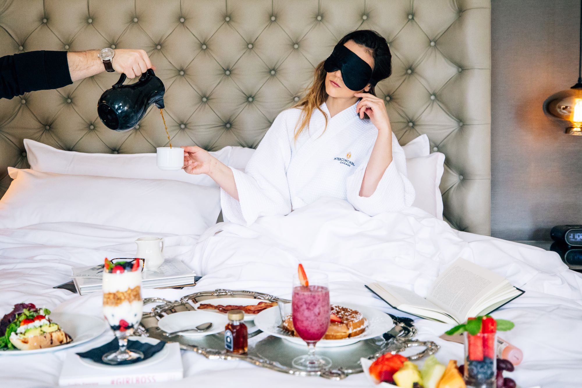 woman in bed being served breakfast