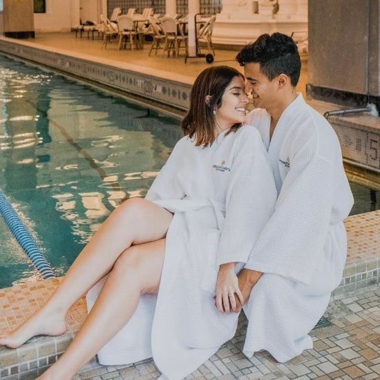 Couple in robes enjoying the pool