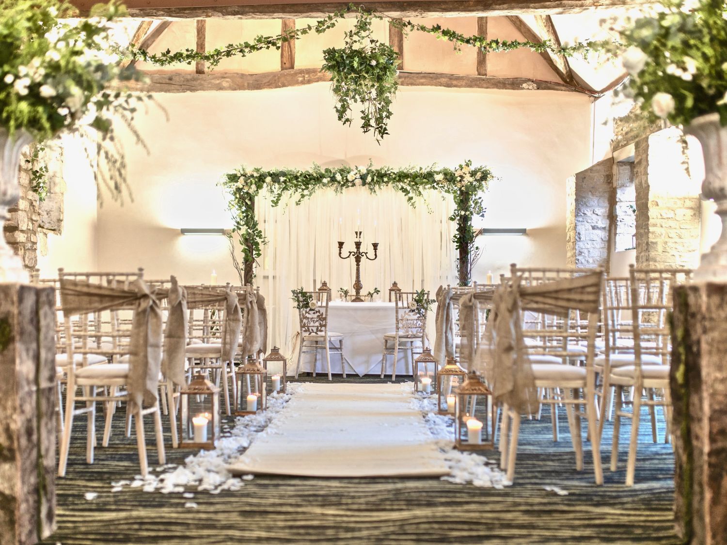 White themed wedding ceremony with chairs and an aisle