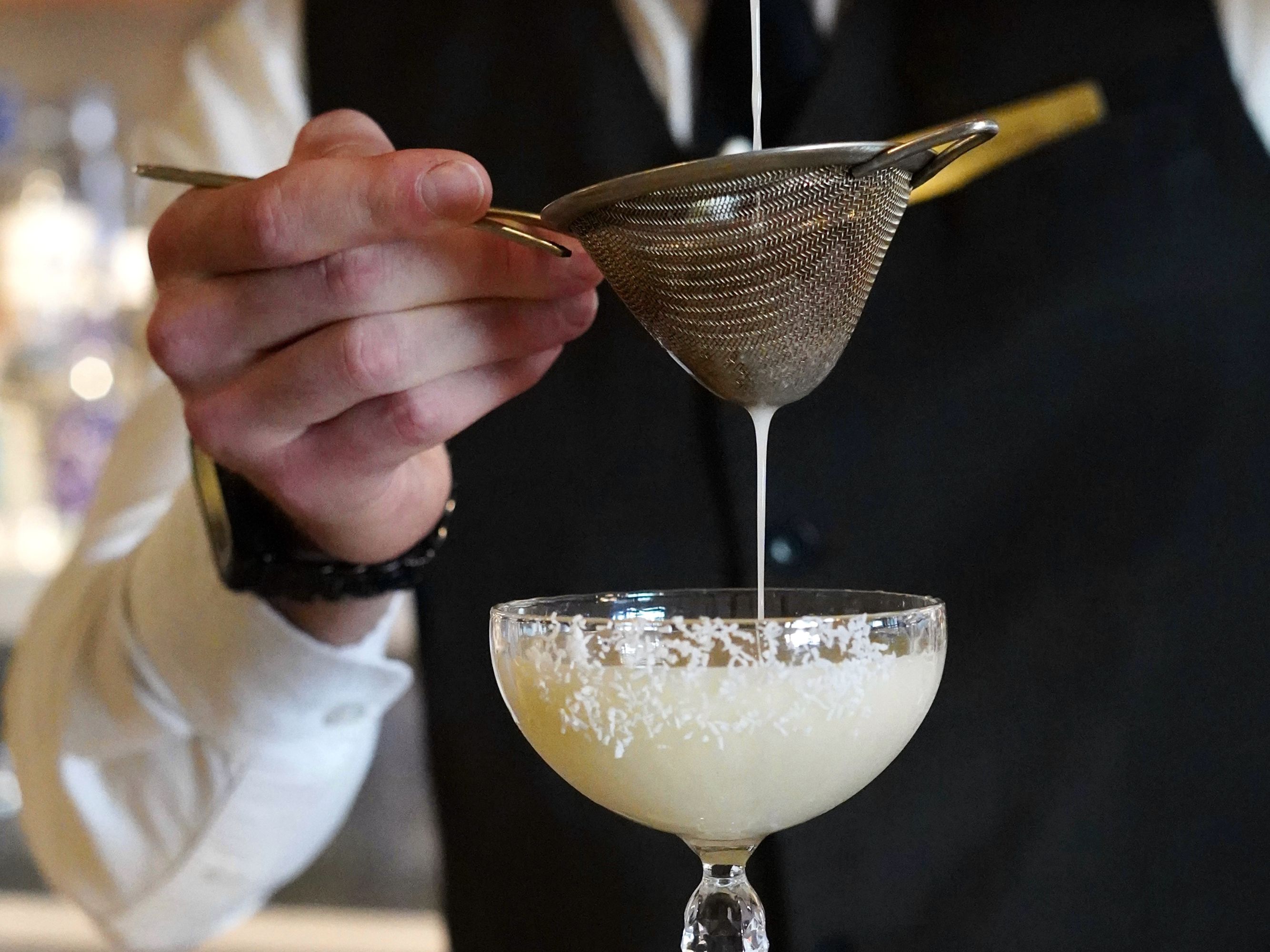 bartender straining drink