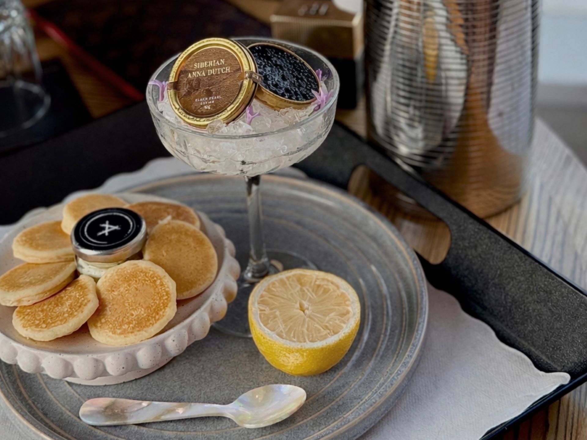 Champagne and caviar set up on tray.