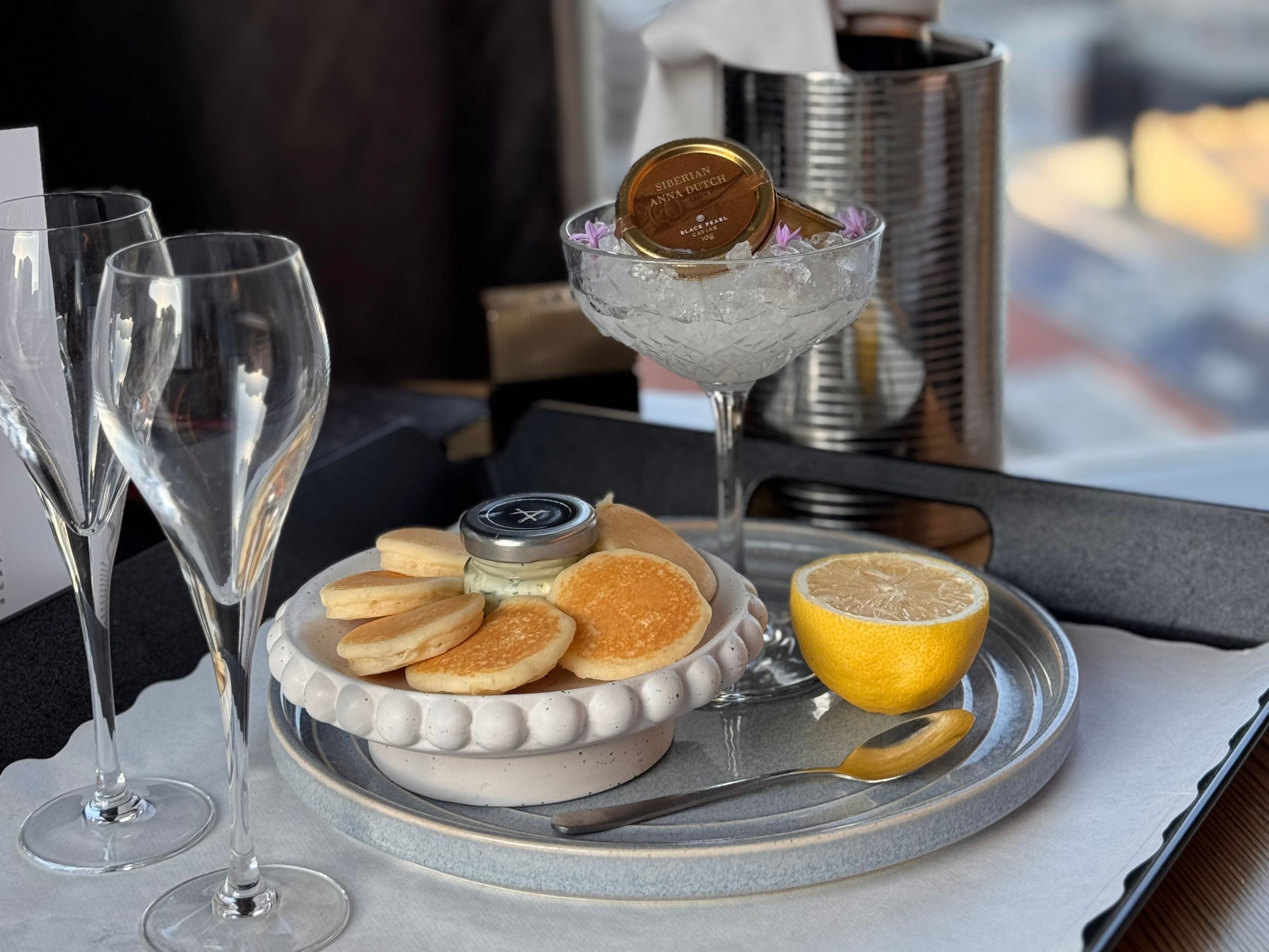Champagne and caviar set up on tray.