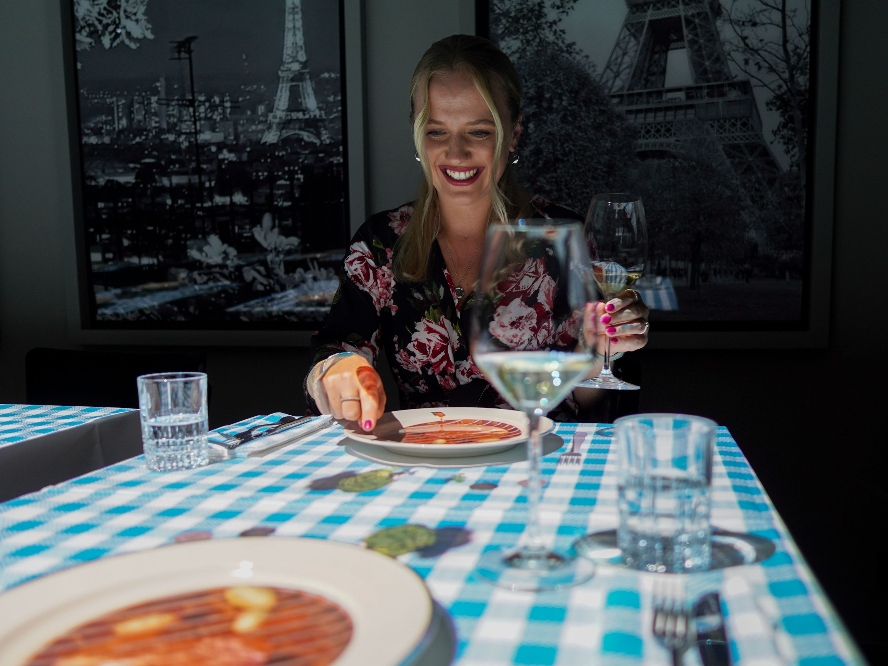 Woman enjoying a meal from le petit chef