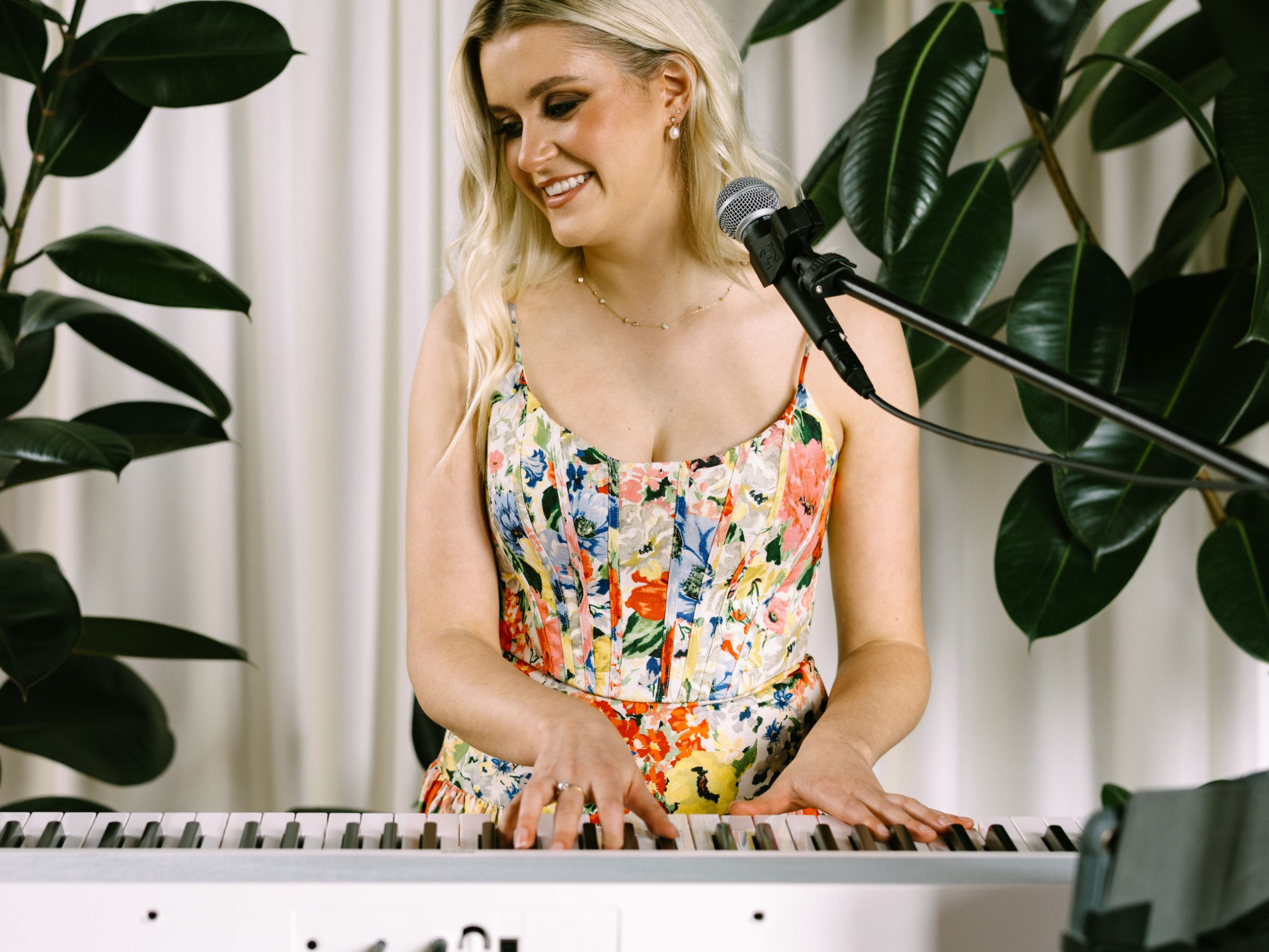Woman playing the piano and singing.