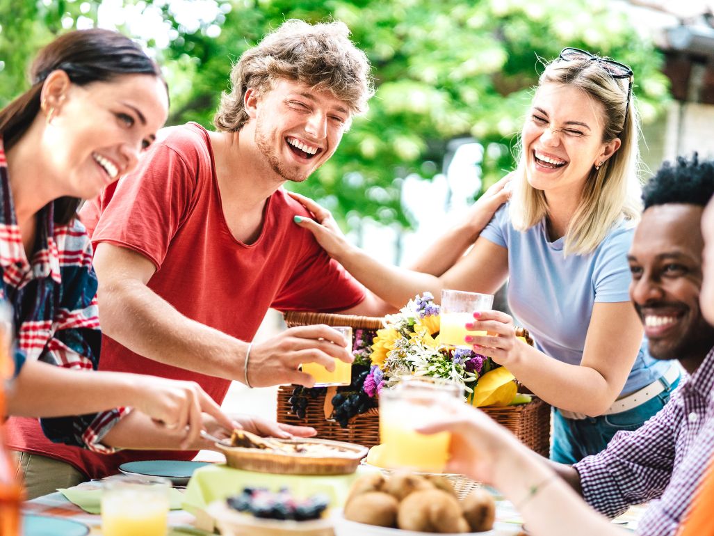 Group of friends sharing lunch at picnic table
