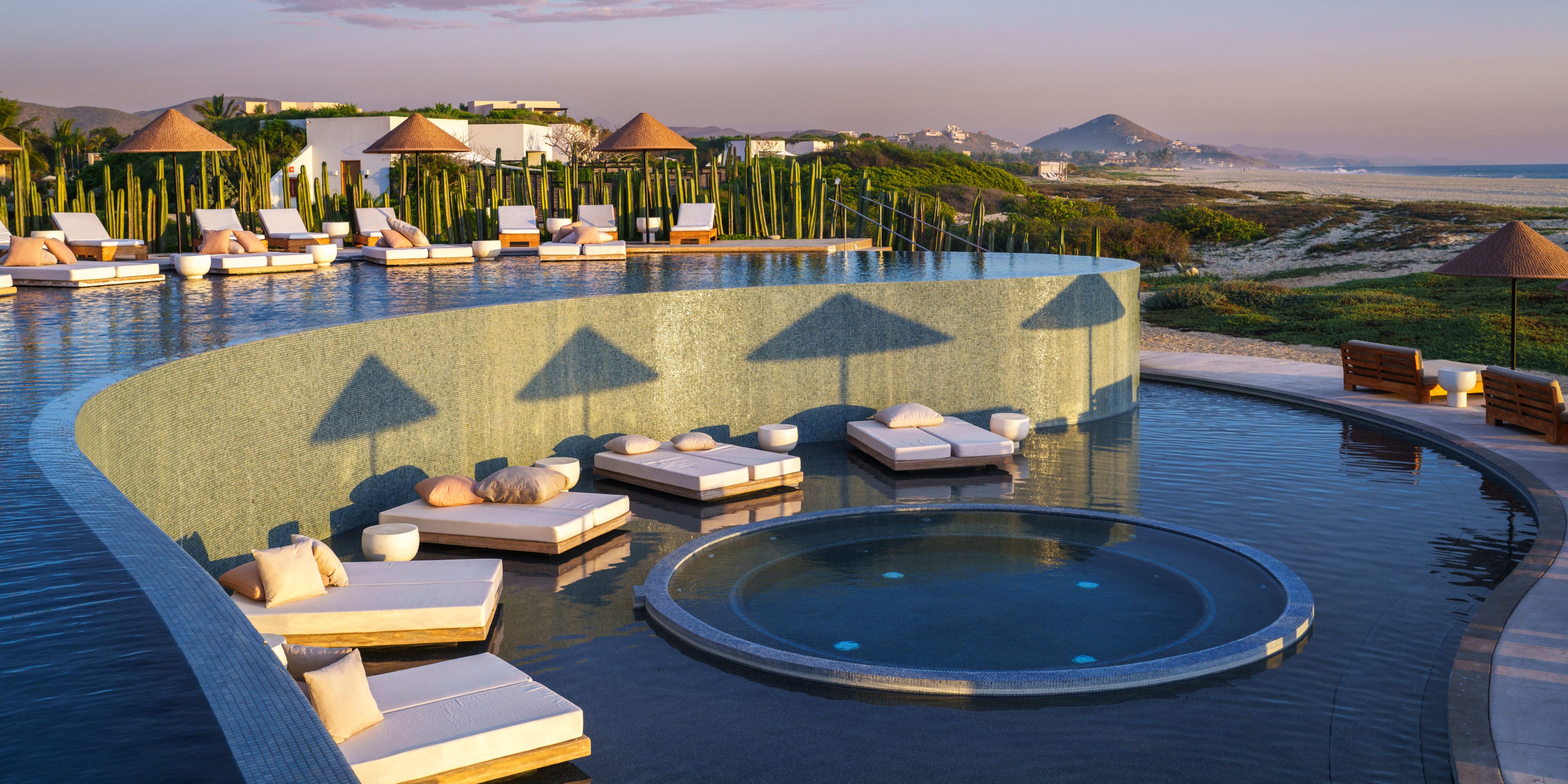 Pool with lounge chairs and mountain views.