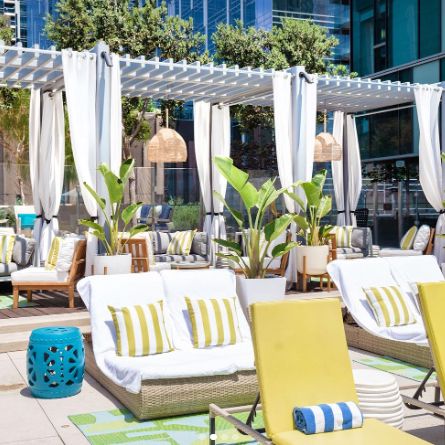Lounge chairs on pool deck at Hotel Indigo Los Angeles