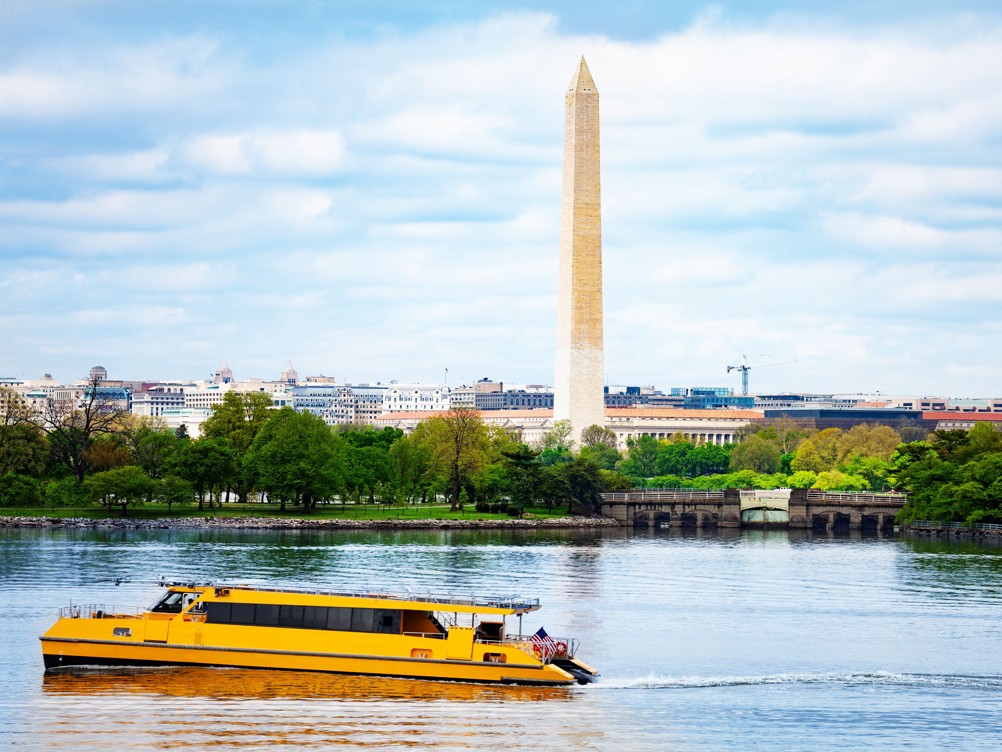 Yellow water taxi on the Potomac River in front of the Washington National Monument.