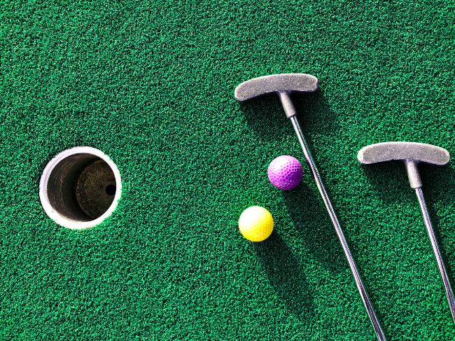 Putter with mini golf balls