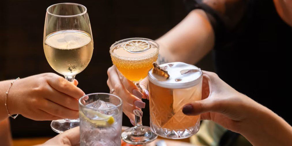 Guests cheering cocktails at The Refuge