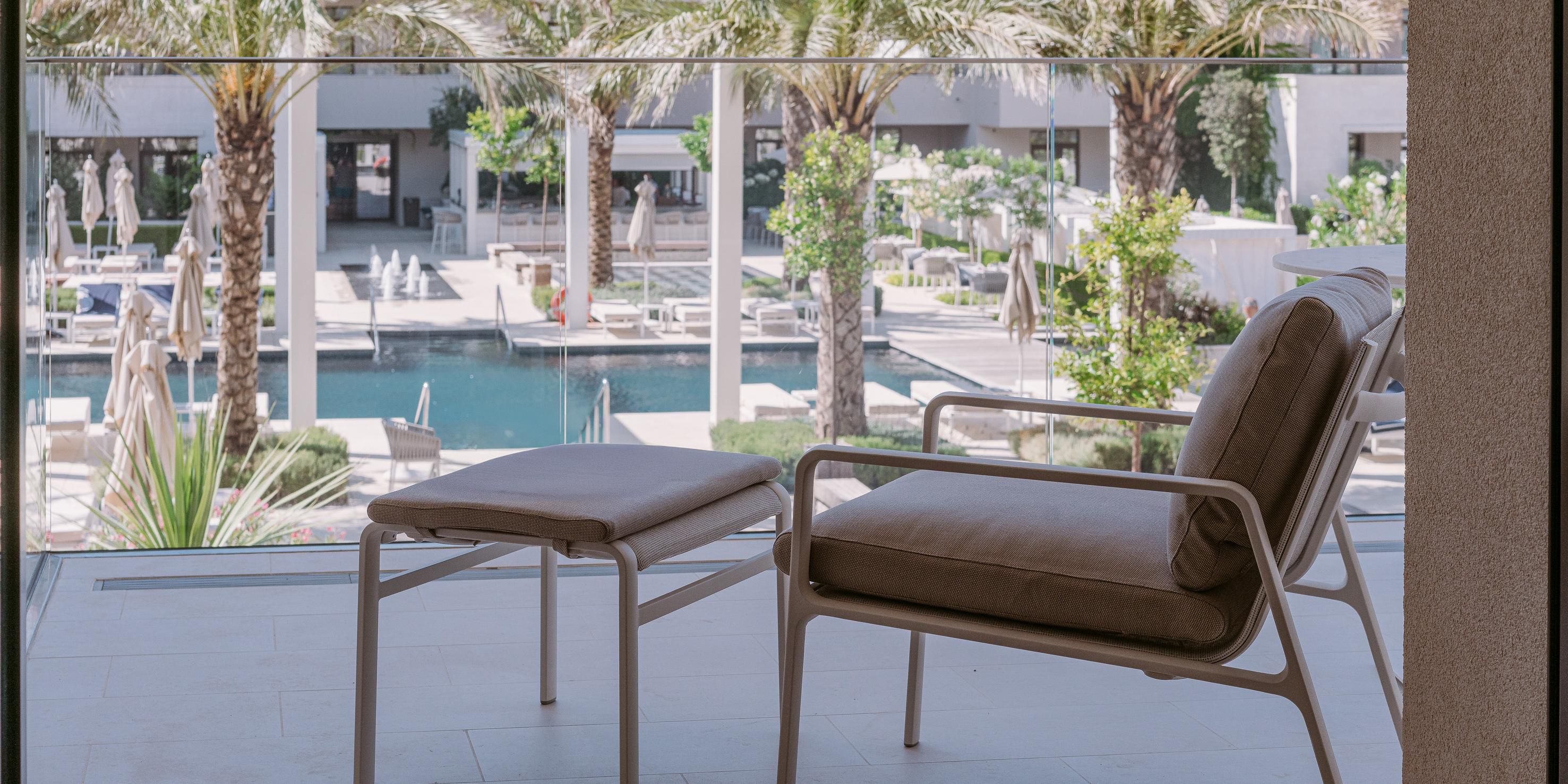 Charming balcony with a serene view of the pool area