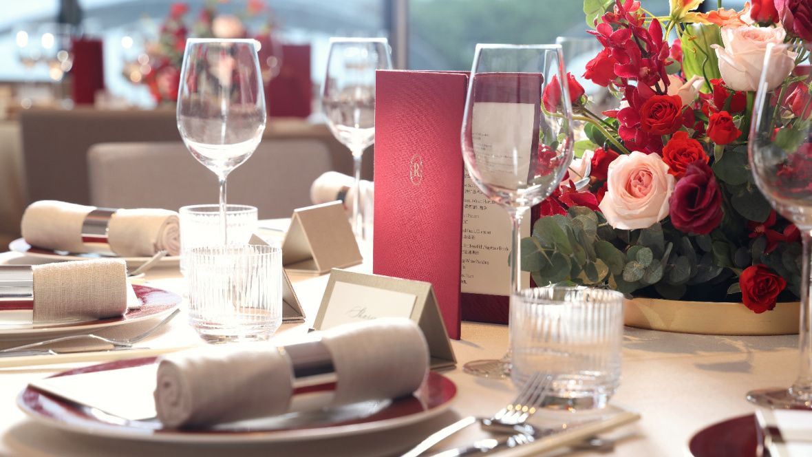 close up of a formally set table with colorful flowers