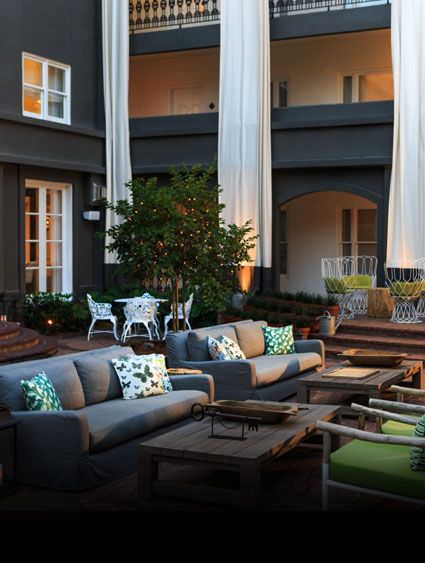 outdoor brick patio with white and gray seating and green accents