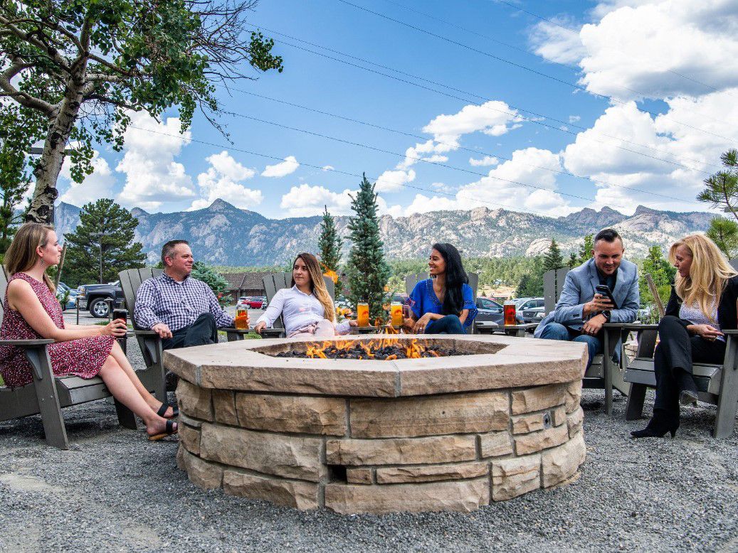 Guests enjoying fire pit outsite of hotel