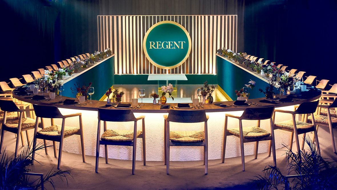 circular long table set for a meal with dramatic lighting