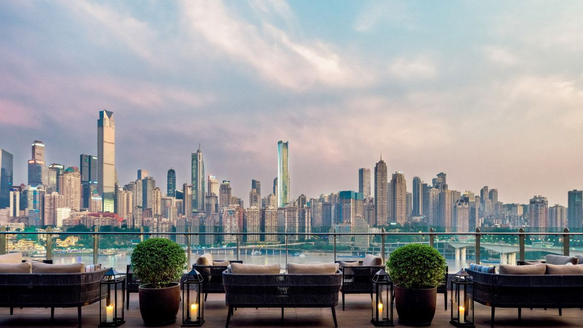 rooftop lounge overlooking water and city skyline