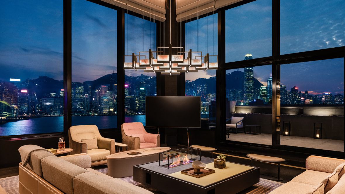 large suite living room overlooking water, city views and the mountains