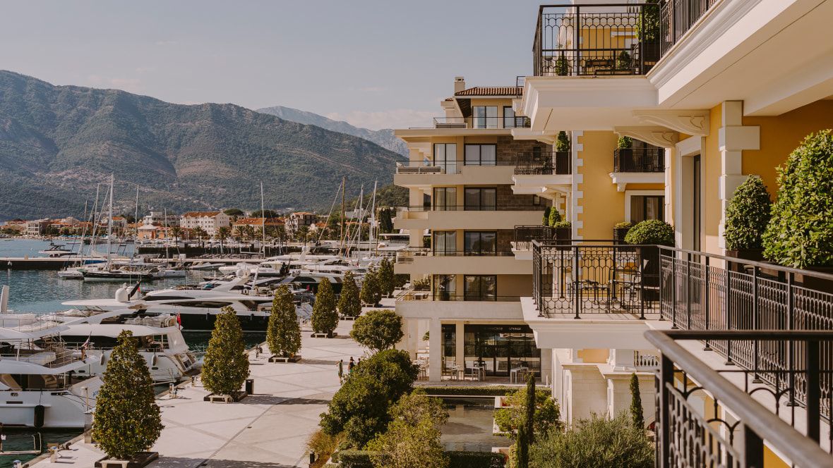 hotel exterior overlooking harbour with row of yachts