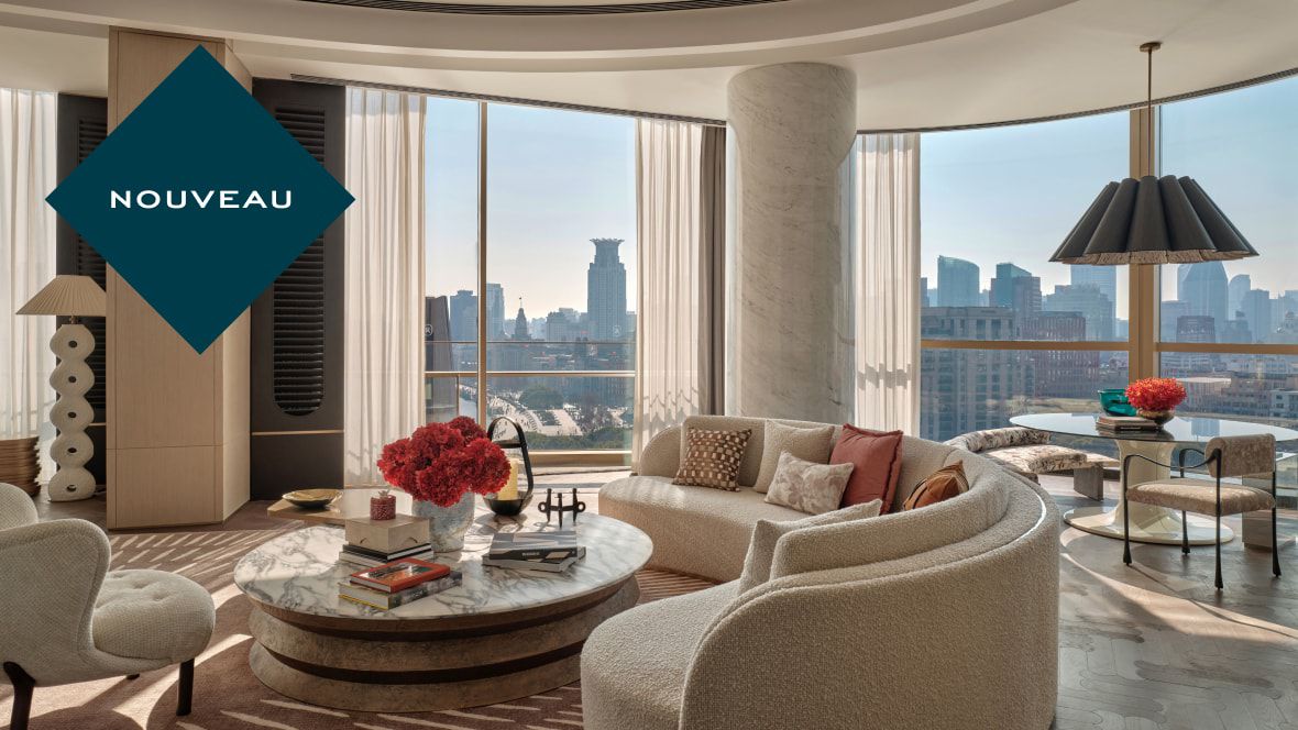 suite avec canapé incurvé, table à manger et vue imprenable sur la ville