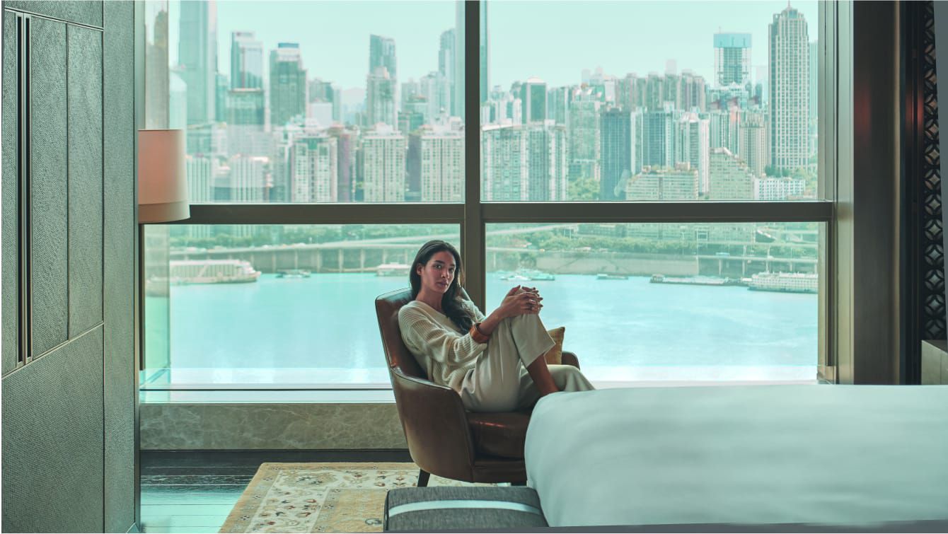 A guest room offers sweeping views of the Chongqing skyline