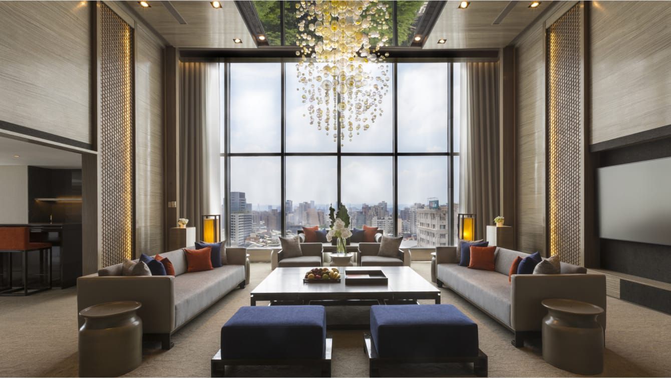 A contemporary seating area shines under a sparkling chandelier