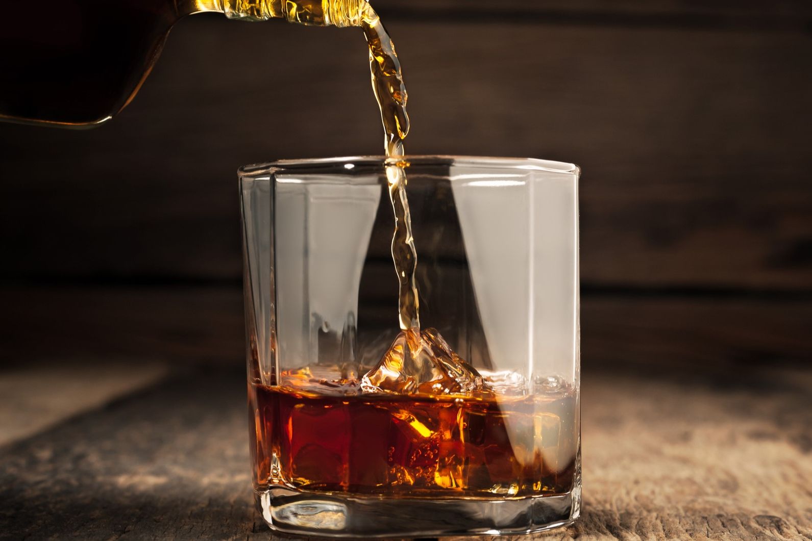 Rum being poured into a glass.