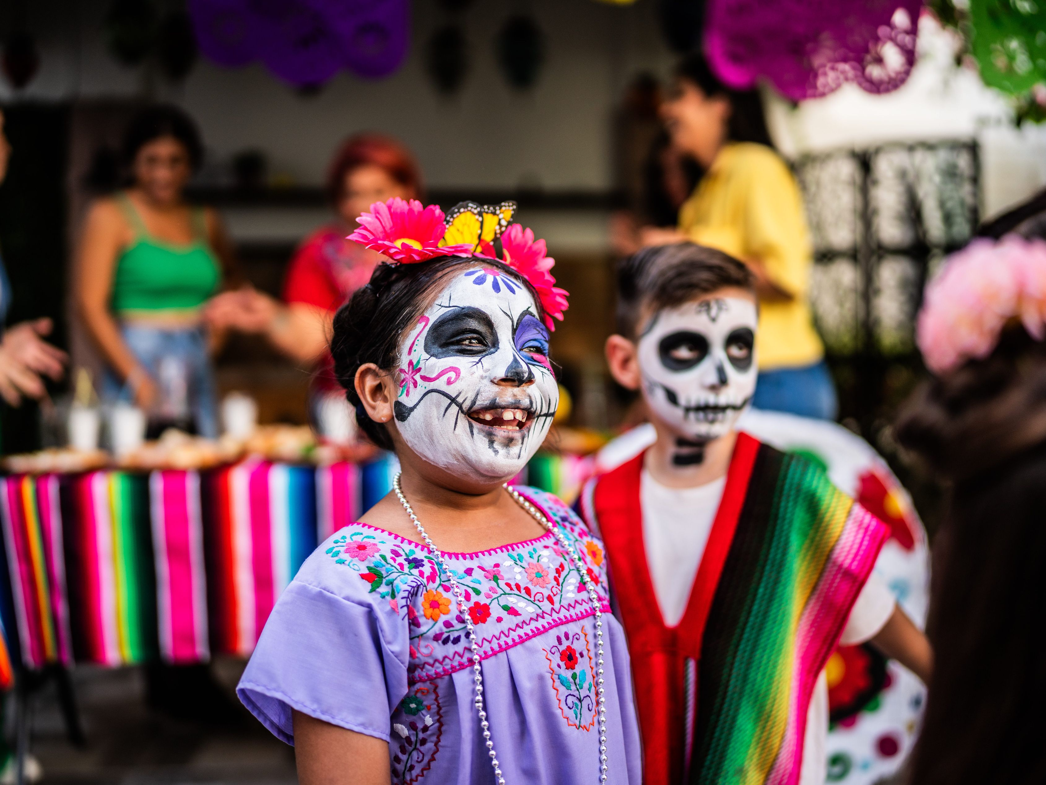 Children with face paintings of sugar skulls
