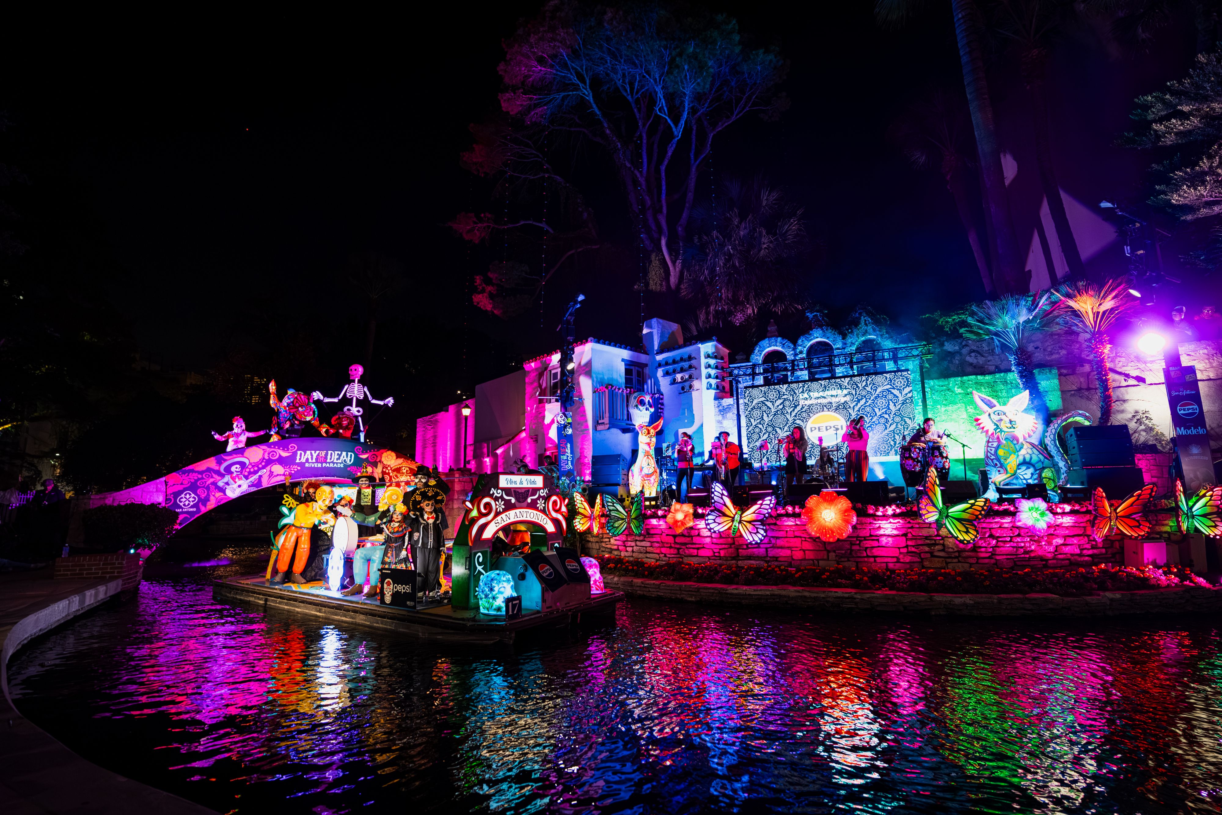 Day of the Dead River Parade float on illuminated waterway