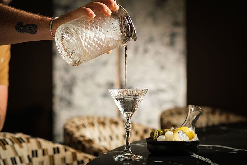 Cocktail pouring into a glass