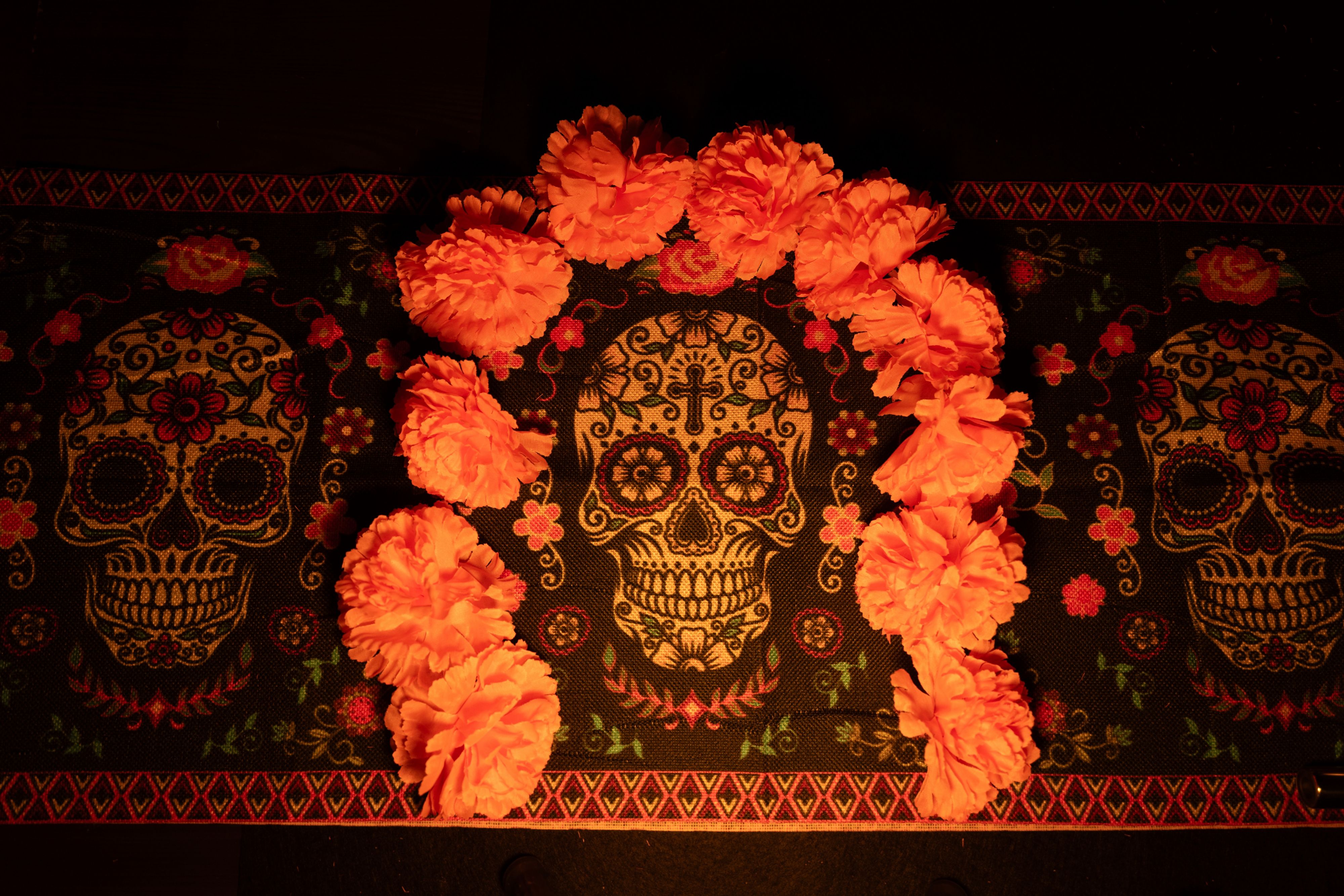 skull with marigolds around it