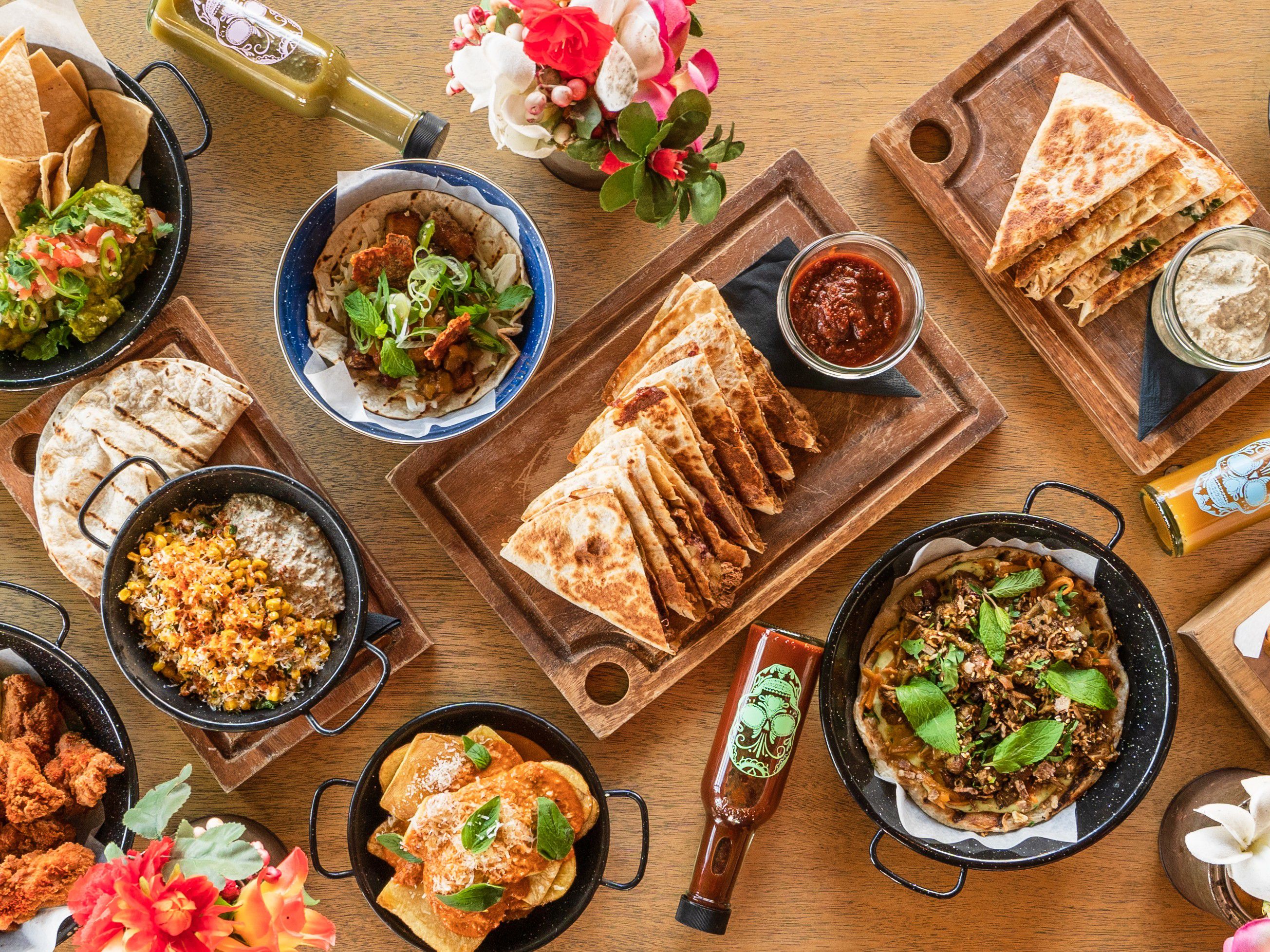 Assorted Mexican-inspired dishes served family-style on a table.