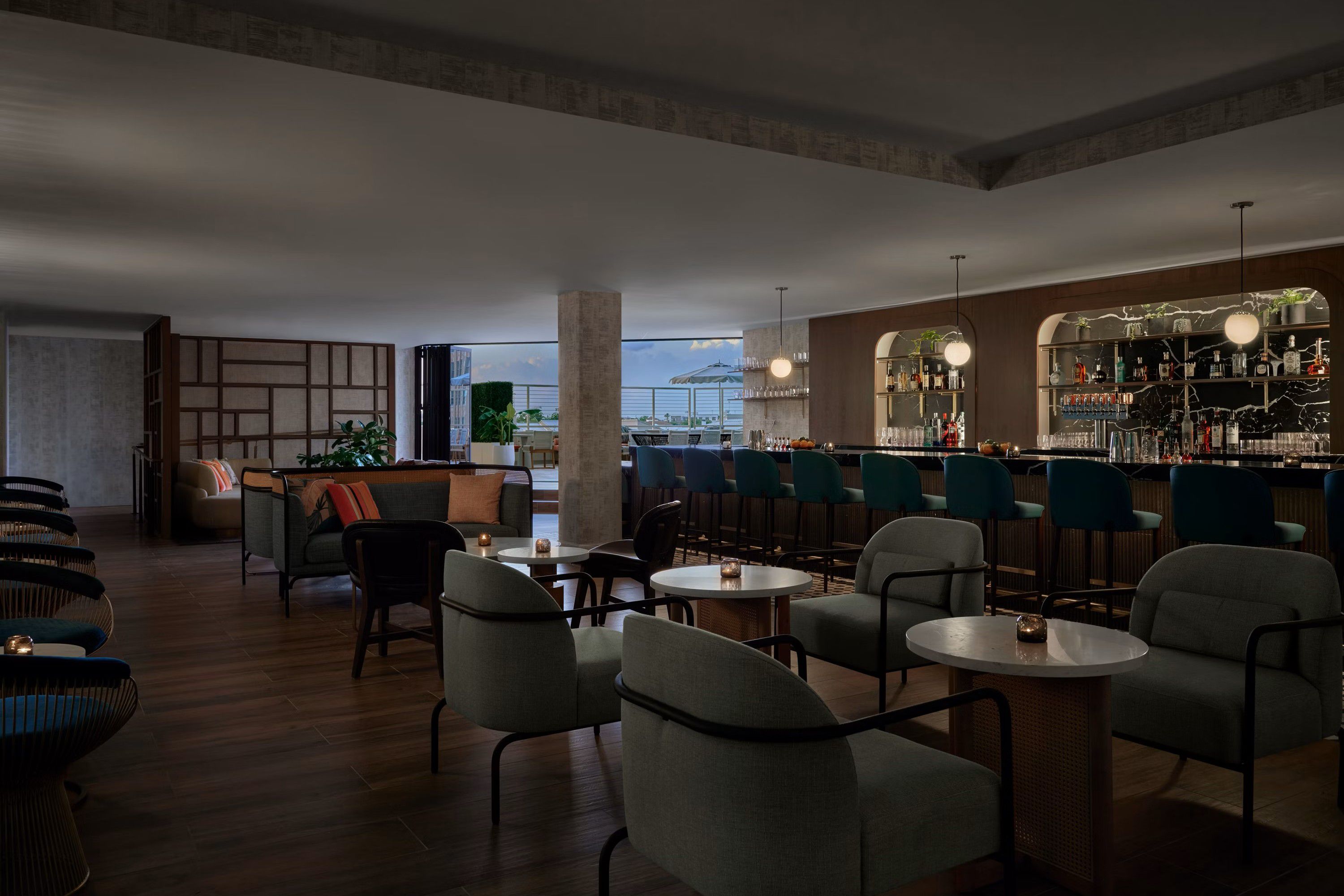 Stylish rooftop lounge featuring bar seating, lounge chairs, and gathering spaces.