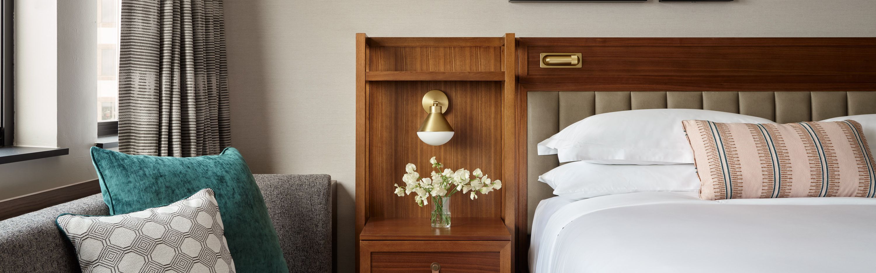 Guest room with king bed, armchair, and bedside table