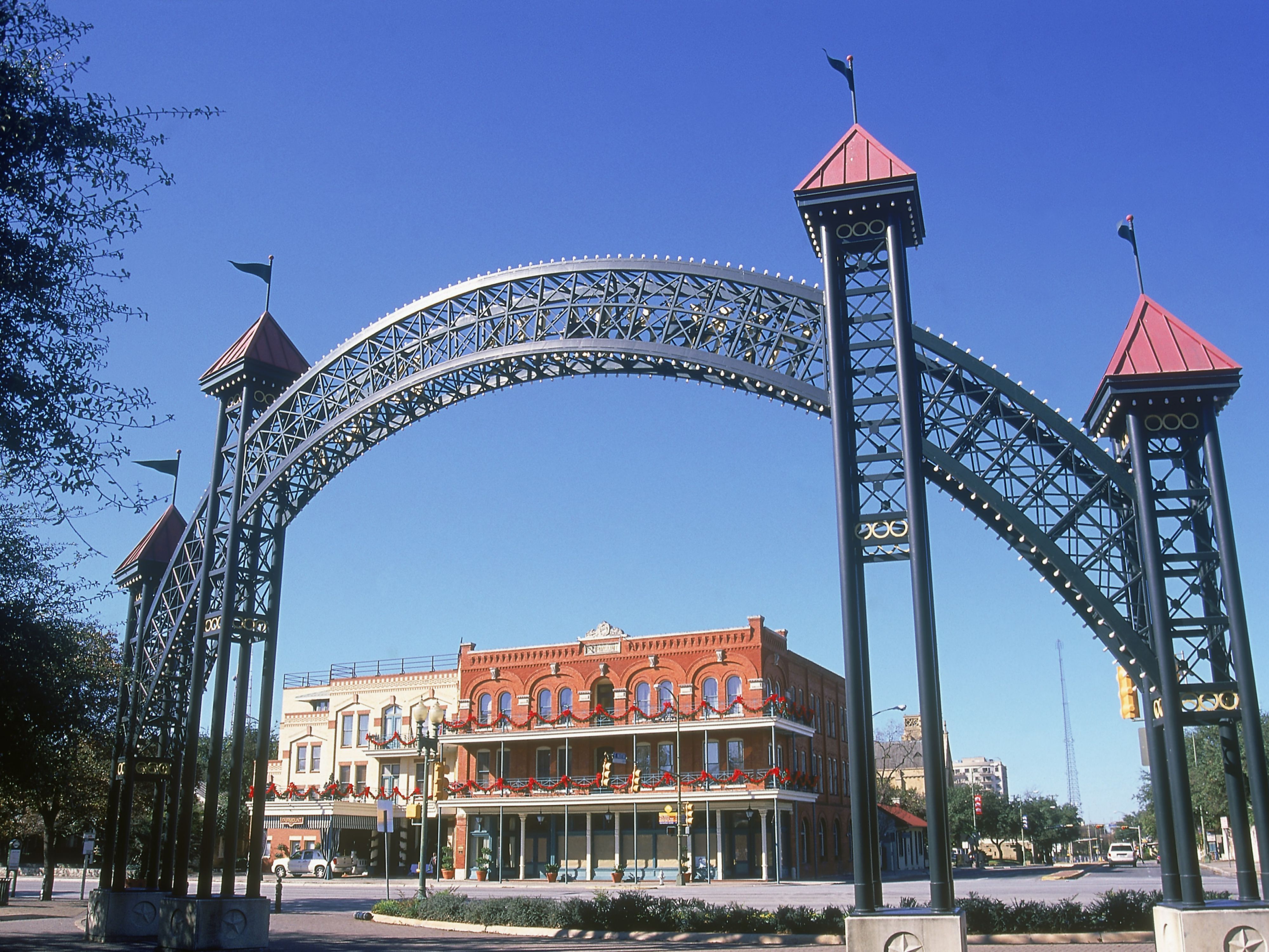 Historic archway and downtown buildings in San Antonio.