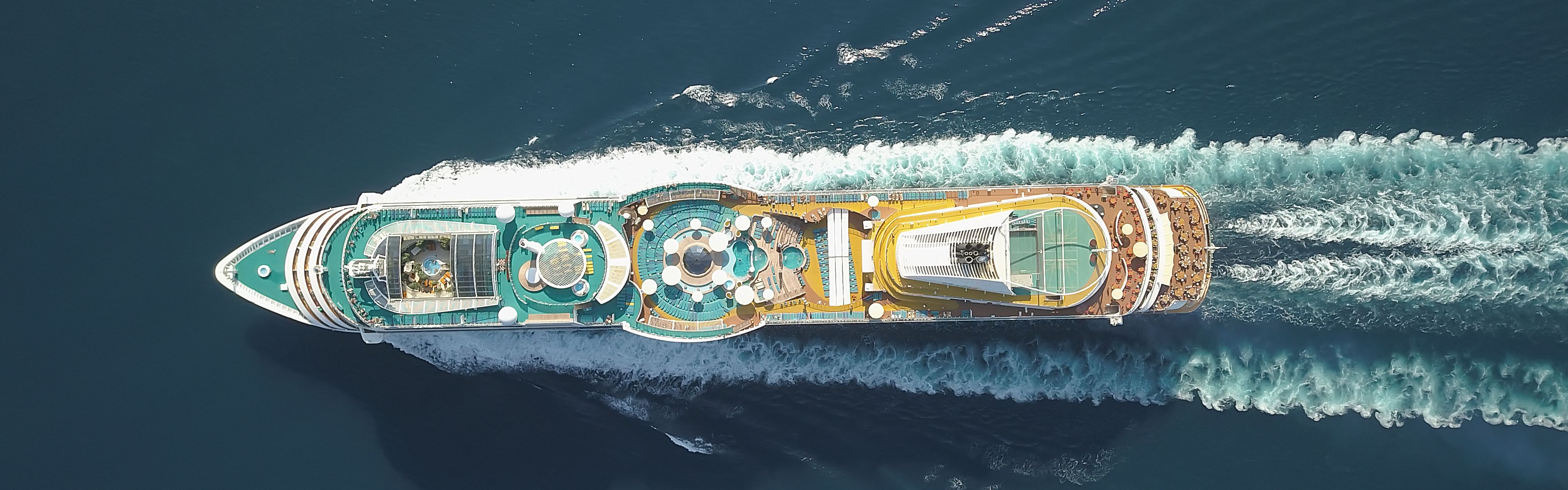 Birdseye view of cruise gliding through the ocean.