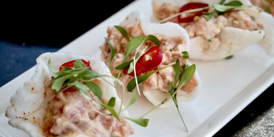 Ahi tuna tartare served in crispy shells, garnished with microgreens and sliced red chili at Top of the Mark in San Francisco.