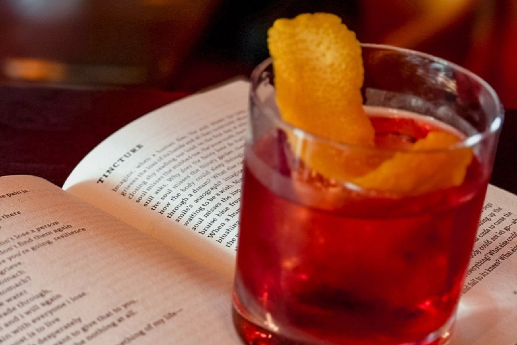 Cocktail resting on a book.