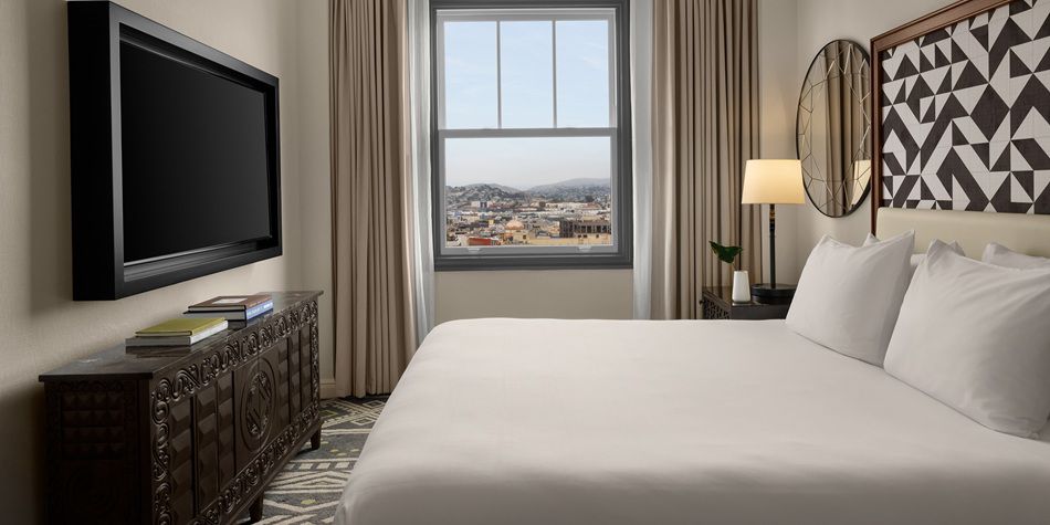 Hotel Spero king guestroom with tv console overlooking San Francisco