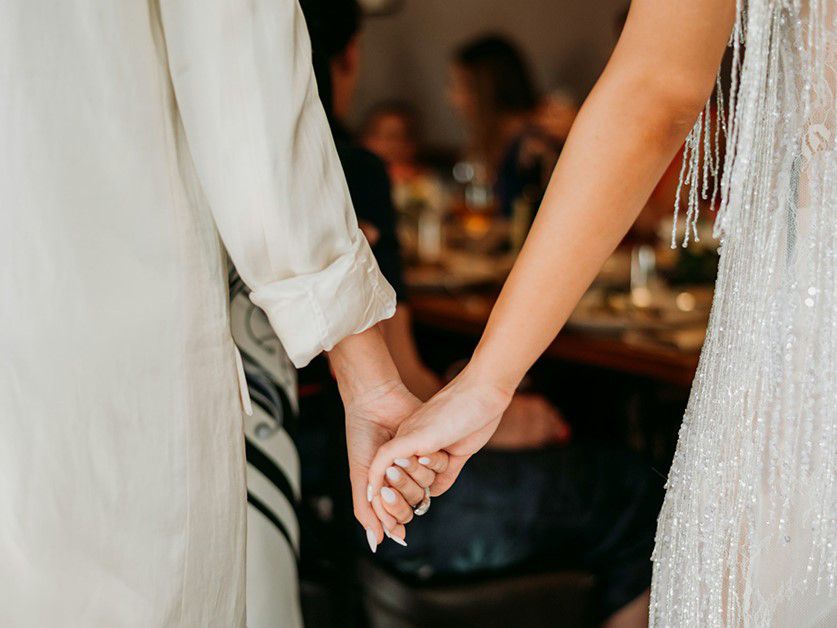 bride and groom holding hands