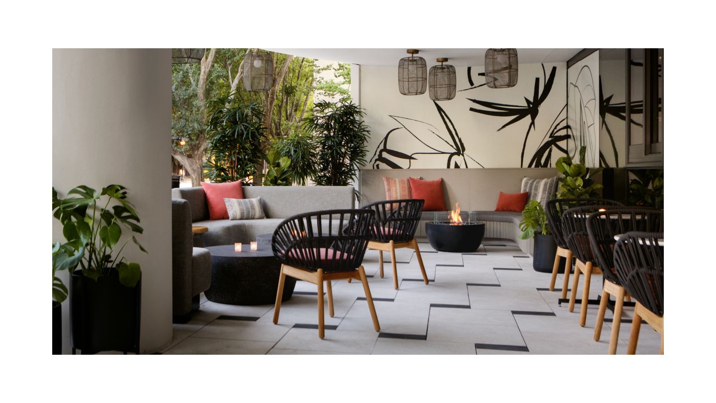 Outdoor bar terrace with modern lounge seating and many plants