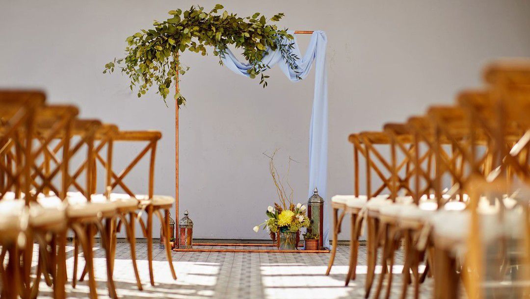 ceremony set up with aisle lined with chairs and yellow flowers
