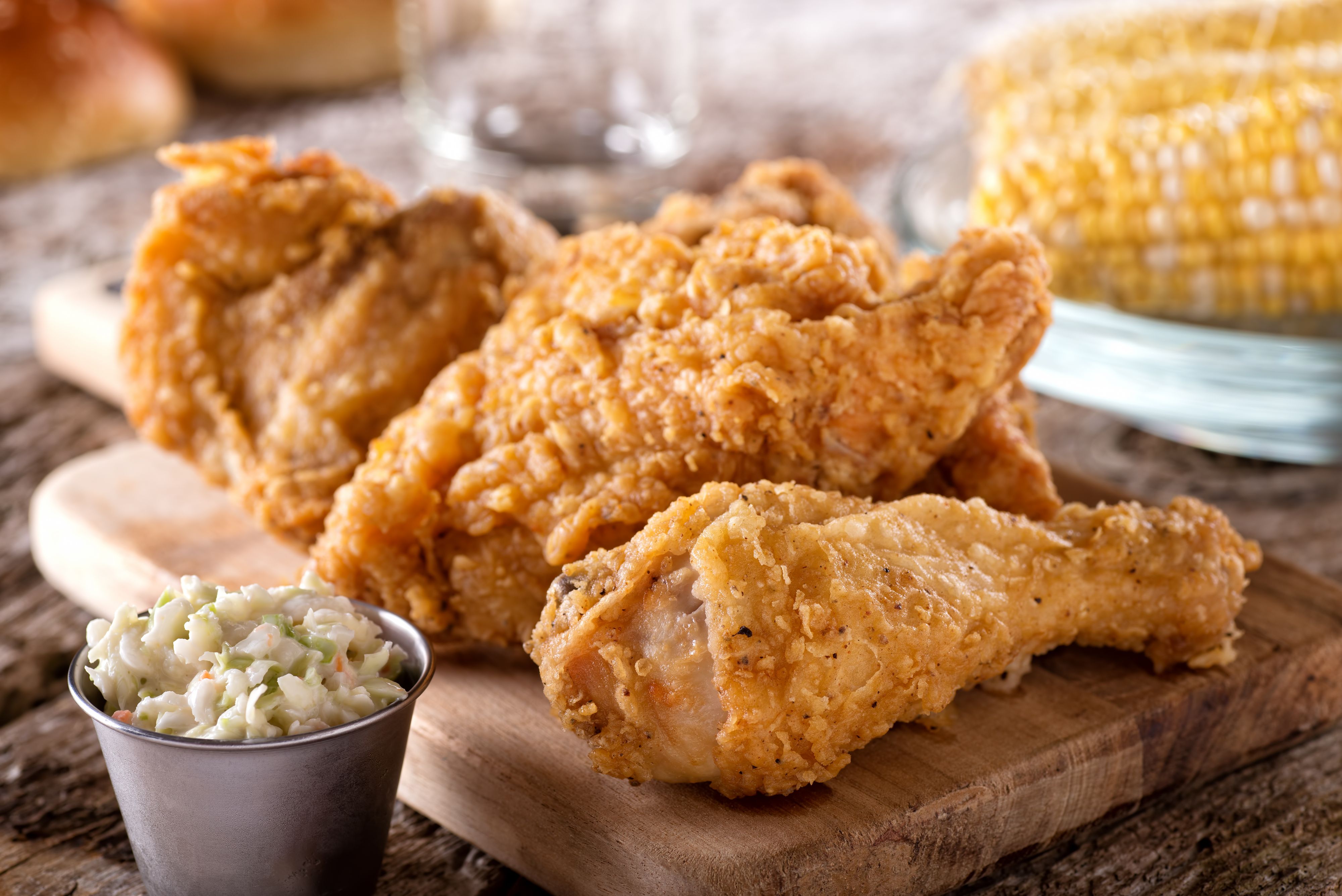 Delicious crispy fried chicken with coleslaw and corn on the cob.