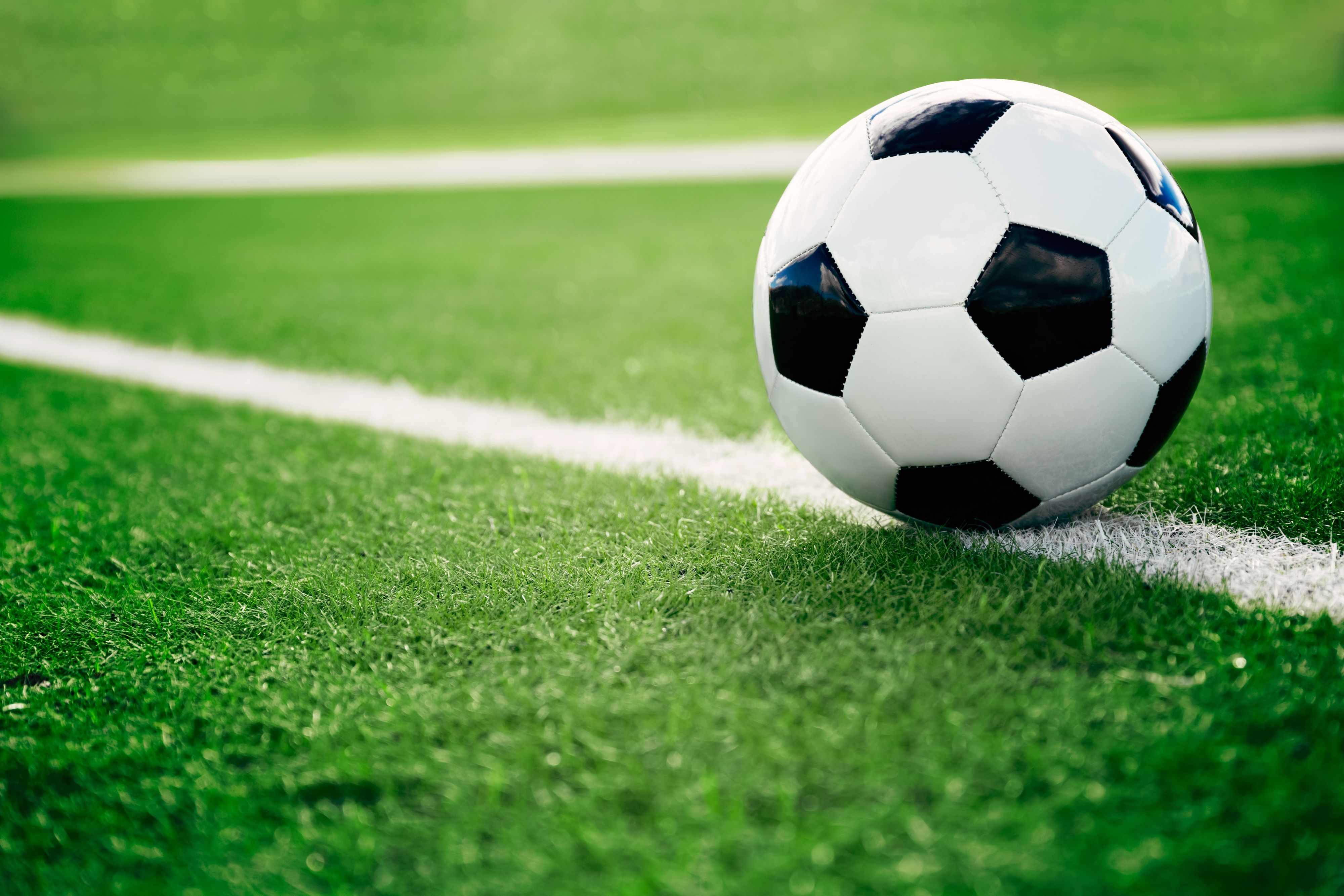 Traditional soccer ball on soccer field