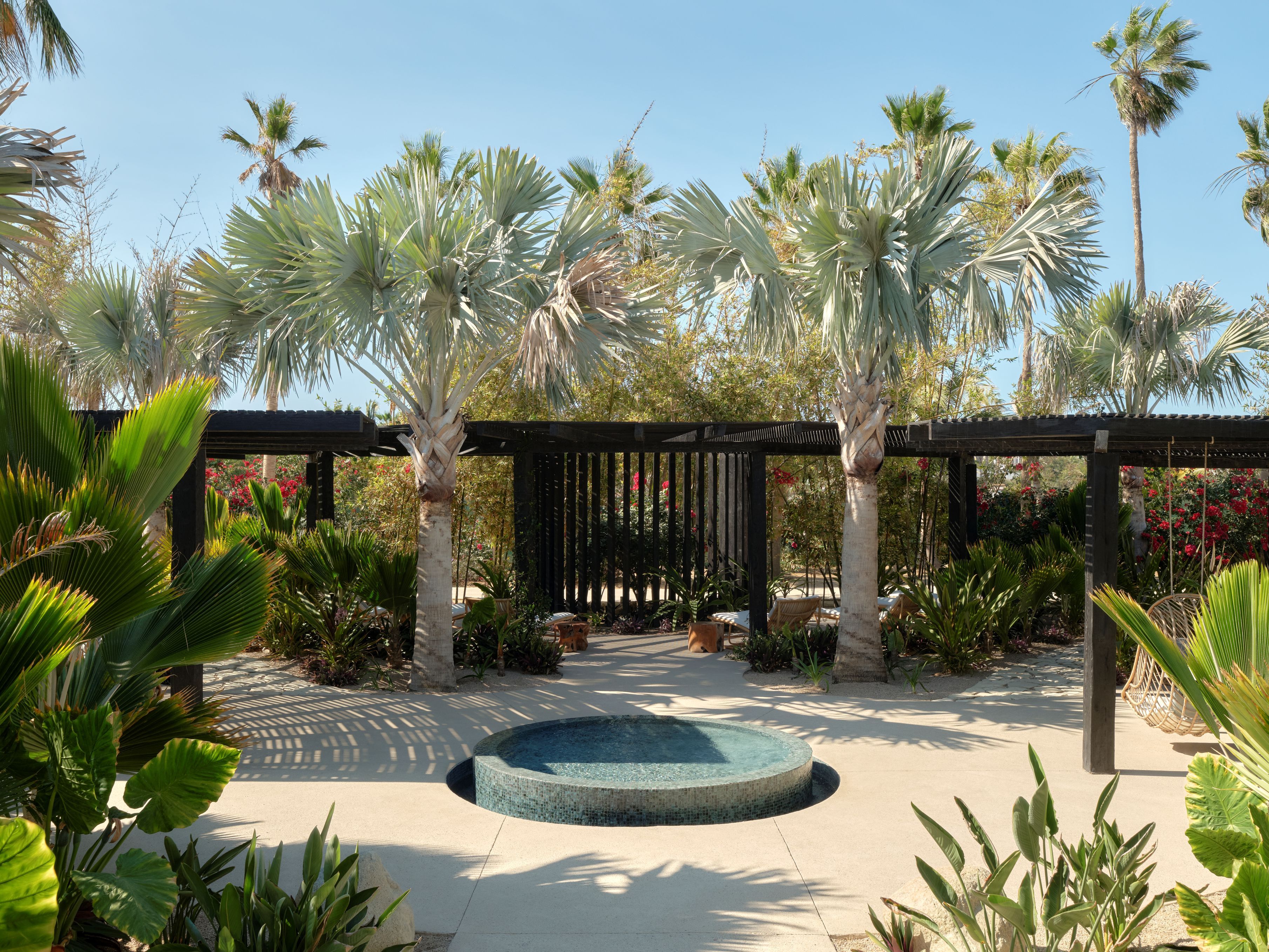 Exterior of the spa with veranda, fountain, and landscaping.
