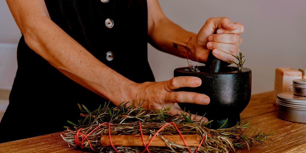Woman grinding herbs in the spa.