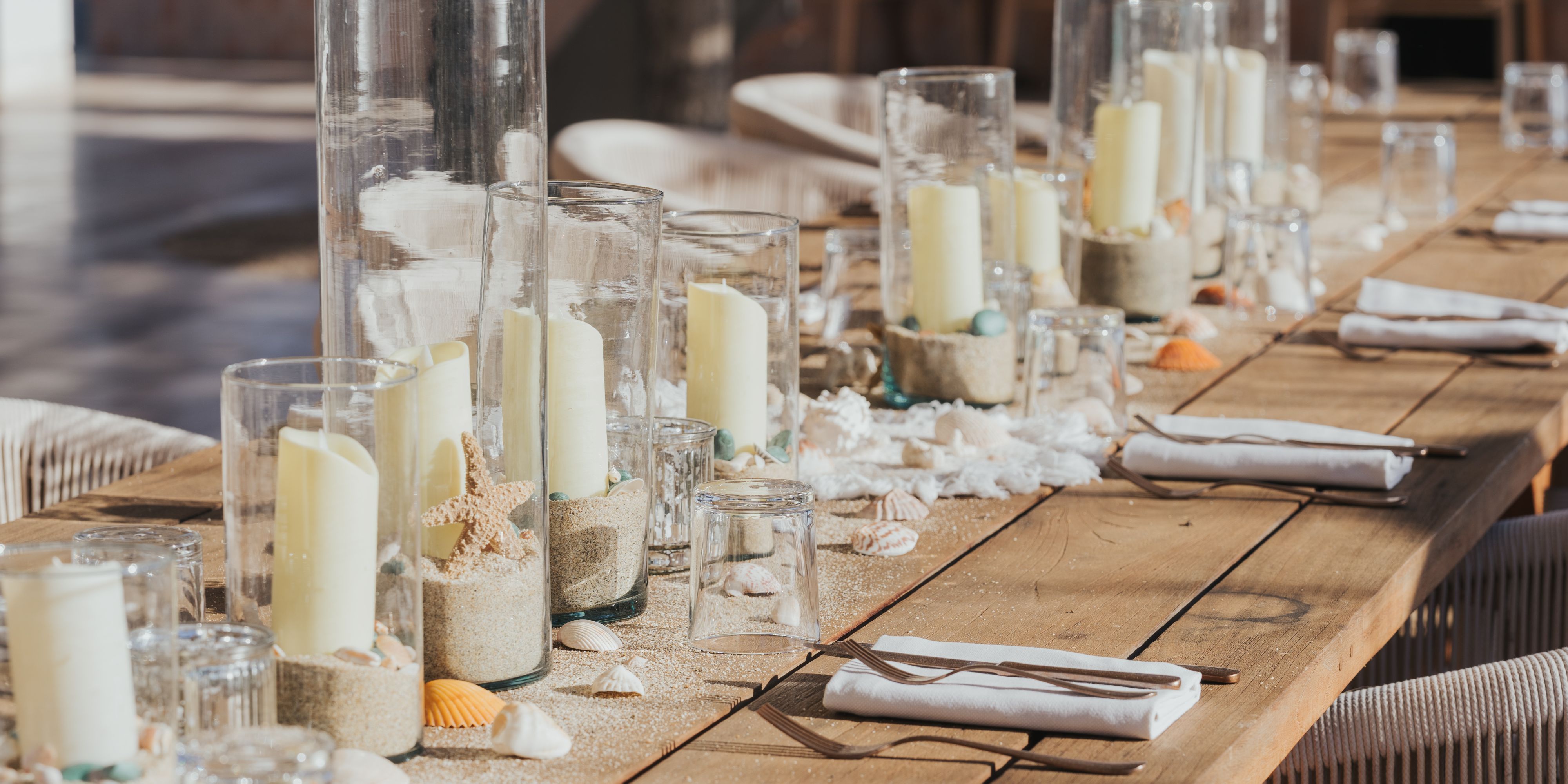 Wedding reception table with candles and decor.