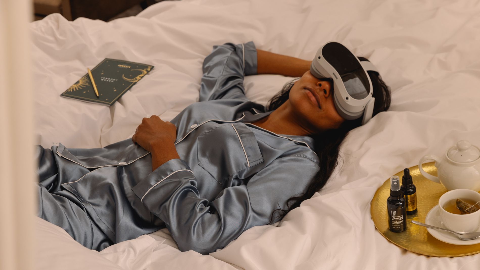 Guest laying down on bed next to room to dream materials