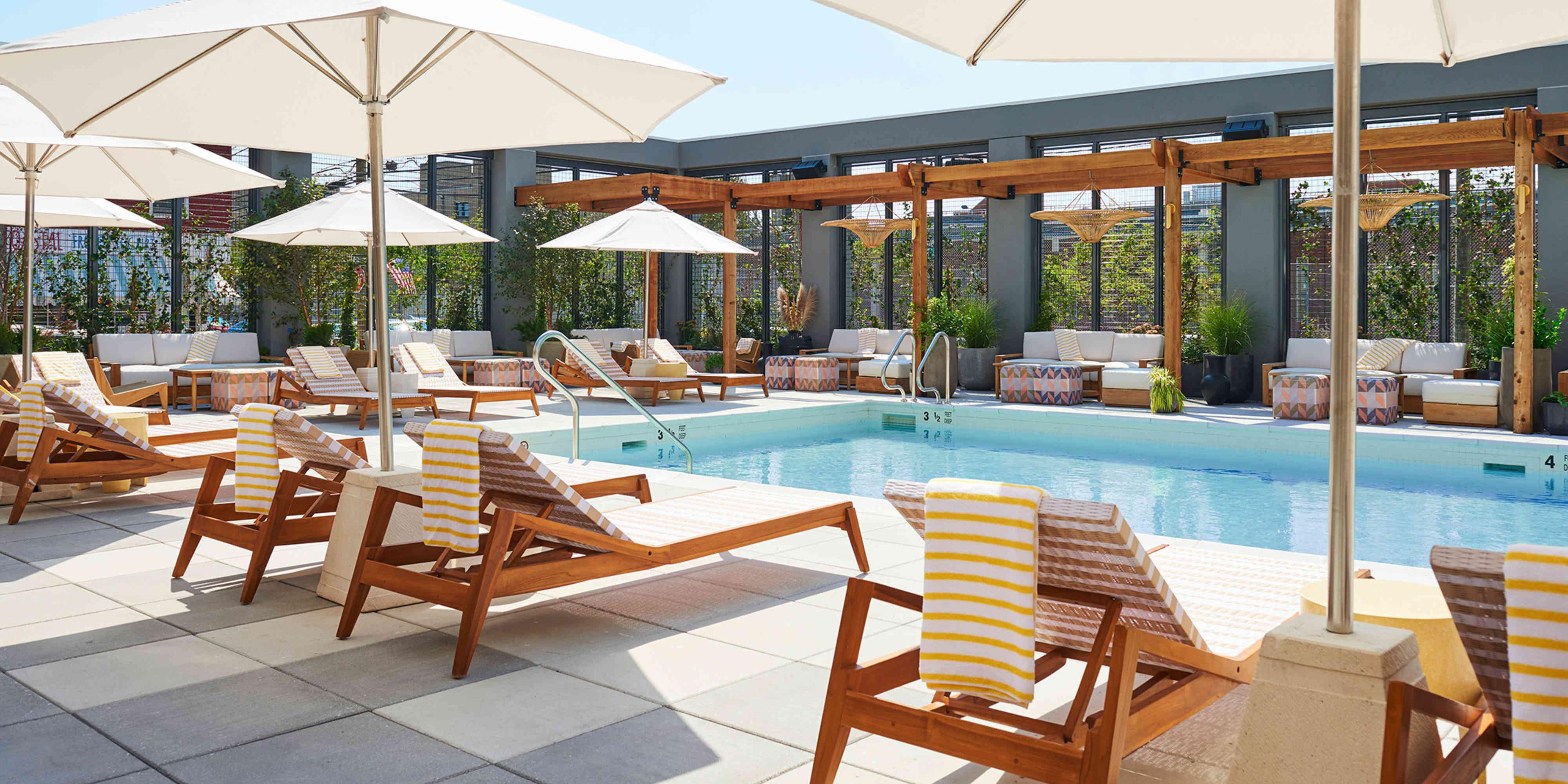 View of the outdoor rooftop pool and cabanas. Come to the Rockaways.