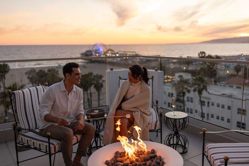 couple sitting in front of a firepit